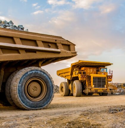 The machinery and dumping trucks outside a coal mining site