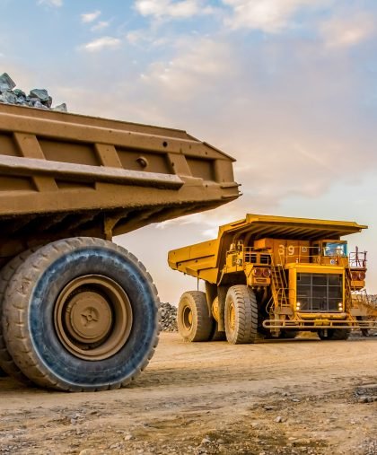 Machinery and dumping trucks outside a coal mining site The machinery and dumping trucks outside a coal mining site