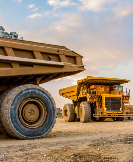 The machinery and dumping trucks outside a coal mining site