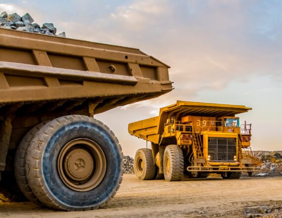 The machinery and dumping trucks outside a coal mining site