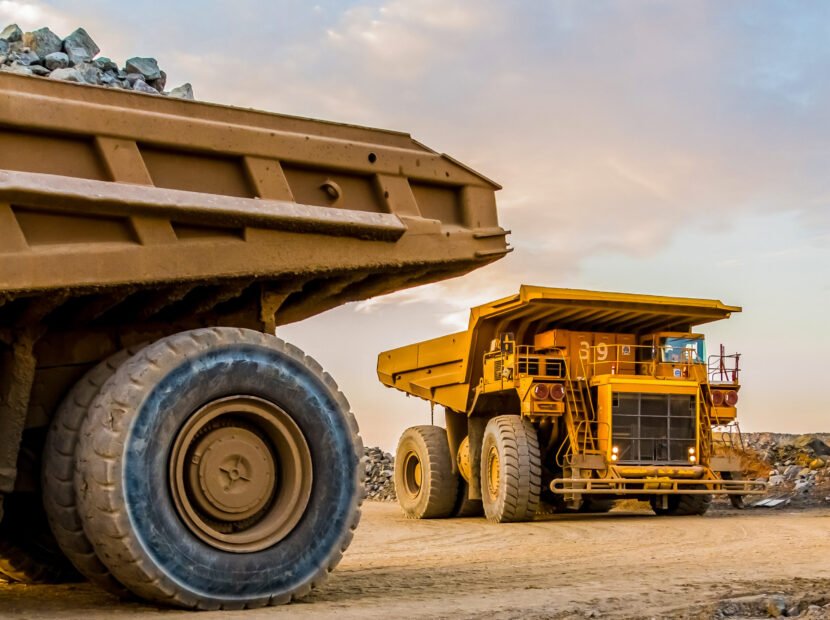 The machinery and dumping trucks outside a coal mining site